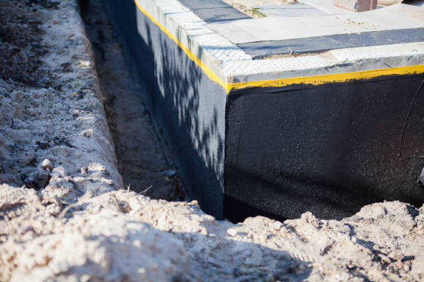 Professional Basement Waterproofing technician working in Hartford, IL
